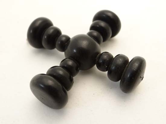 A turned ebonised wooden pendent of cruciform . Approx 2 1/4" long    CONDITION:  Please Note -