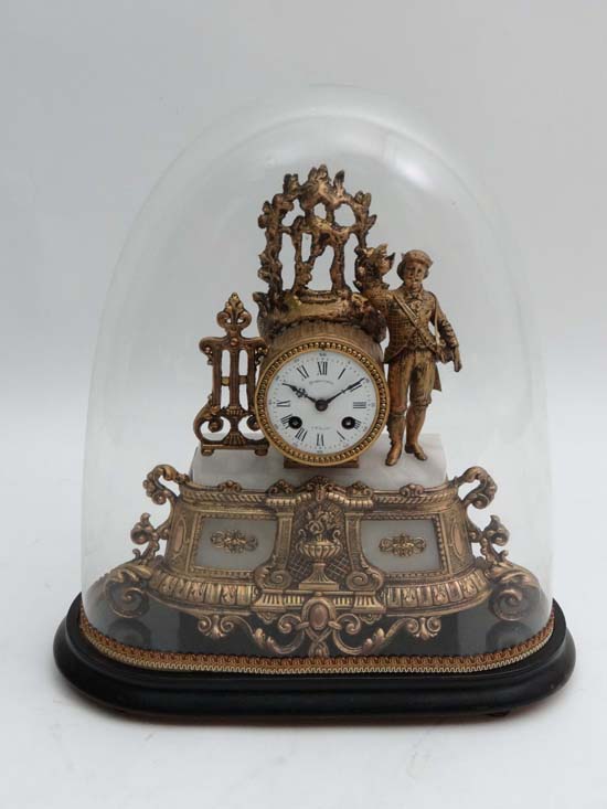 A French gilt metal mantle clock with glass dome and base. Enamel dial signed "Dumouchel A St Saens"