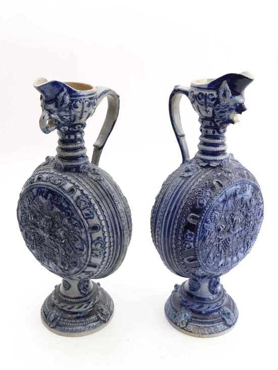 A pair of German grey salt glaze moonflasks with cobalt detail having highly detailed moulding