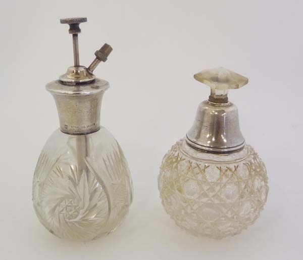 2 cut glass perfume bottles with Sterling silver mounts. The tallest 5 1/2" high