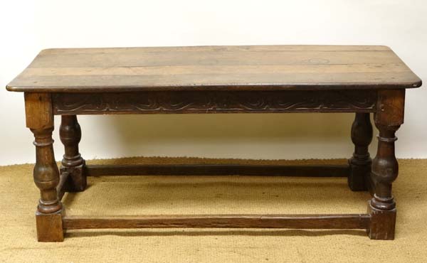 A c.1700 oak table with four plank top, baluster legs and carved frieze etc. 68" long x 27 1/2" wide