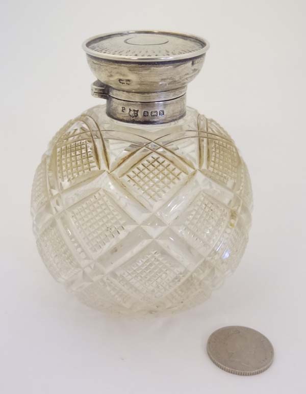 A cut glass perfume bottle of spherical form with HM silver mounts and hinged lid. Birmingham 1907