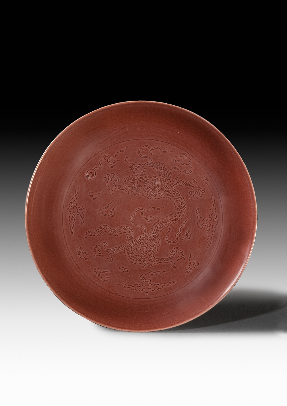 AN AUBERGINE-GLAZED DRAGON CHASING A FLAMING PEARL DISH, JIAQING MARK AND PERIOD, D: 7.6 cm.
With