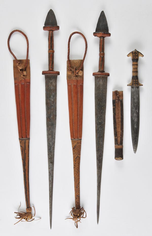 *  A Cameroon sword, the 49cm double edge blade with leather bound grip and iron terminal, 70.5cm