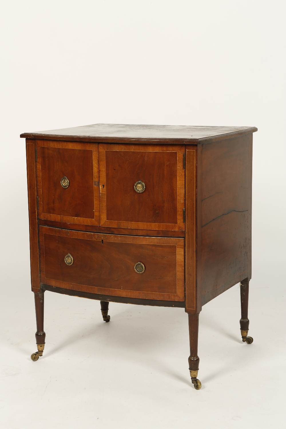 A GEORGE III MAHOGANY COMMODE, the rectangular bow-fronted top with satinwood crossbanding above