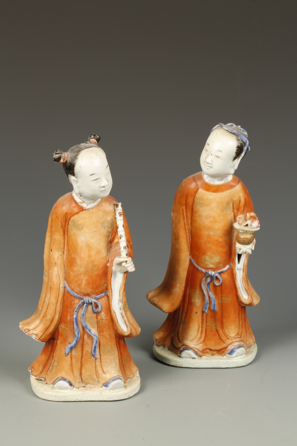 A PAIR OF CHINESE STANDING FIGURES, one holding a bowl and the other with a sceptre, Qing, 9.5""