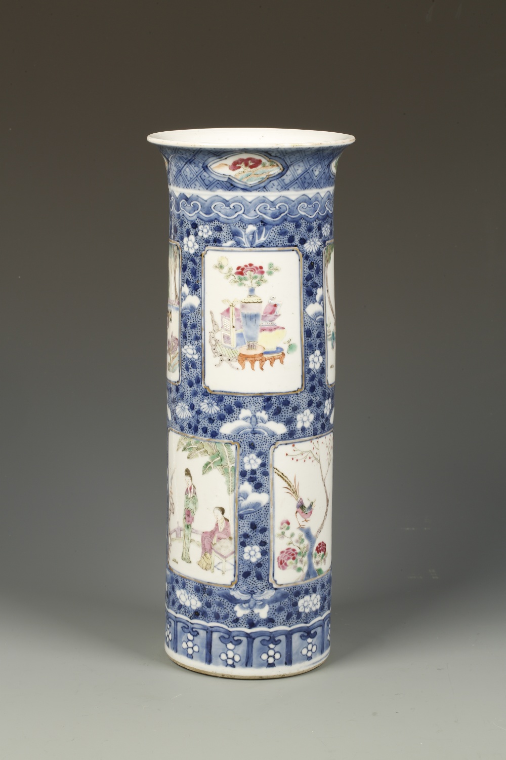 A CHINESE FAMILLE ROSE CYLINDRICAL VASE decorated with rectangular panels showing figures and other