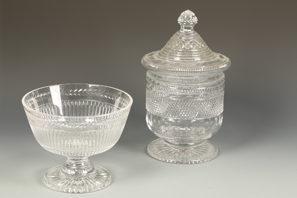 A REGENCY STYLE CLEAR CUT-GLASS PEDESTAL BASIN with an associated raised lid, above a straight-