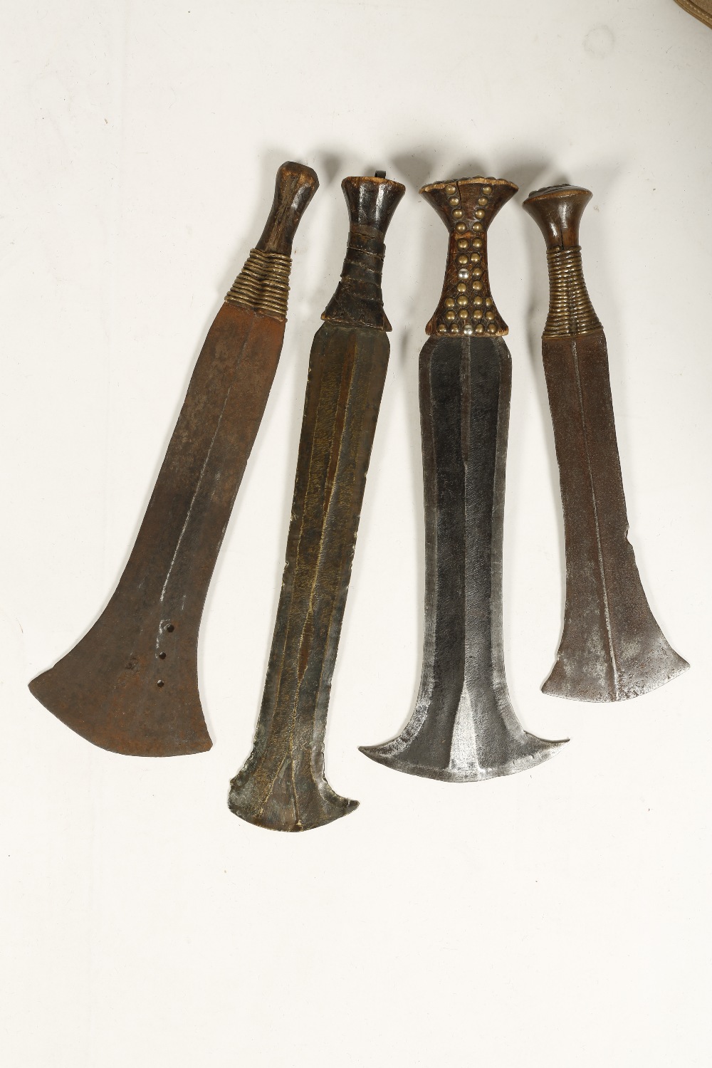 FOUR SPATULAR-SHAPED KNIVES, the blades with flared ends, Congolese, three with metal-wire grips,