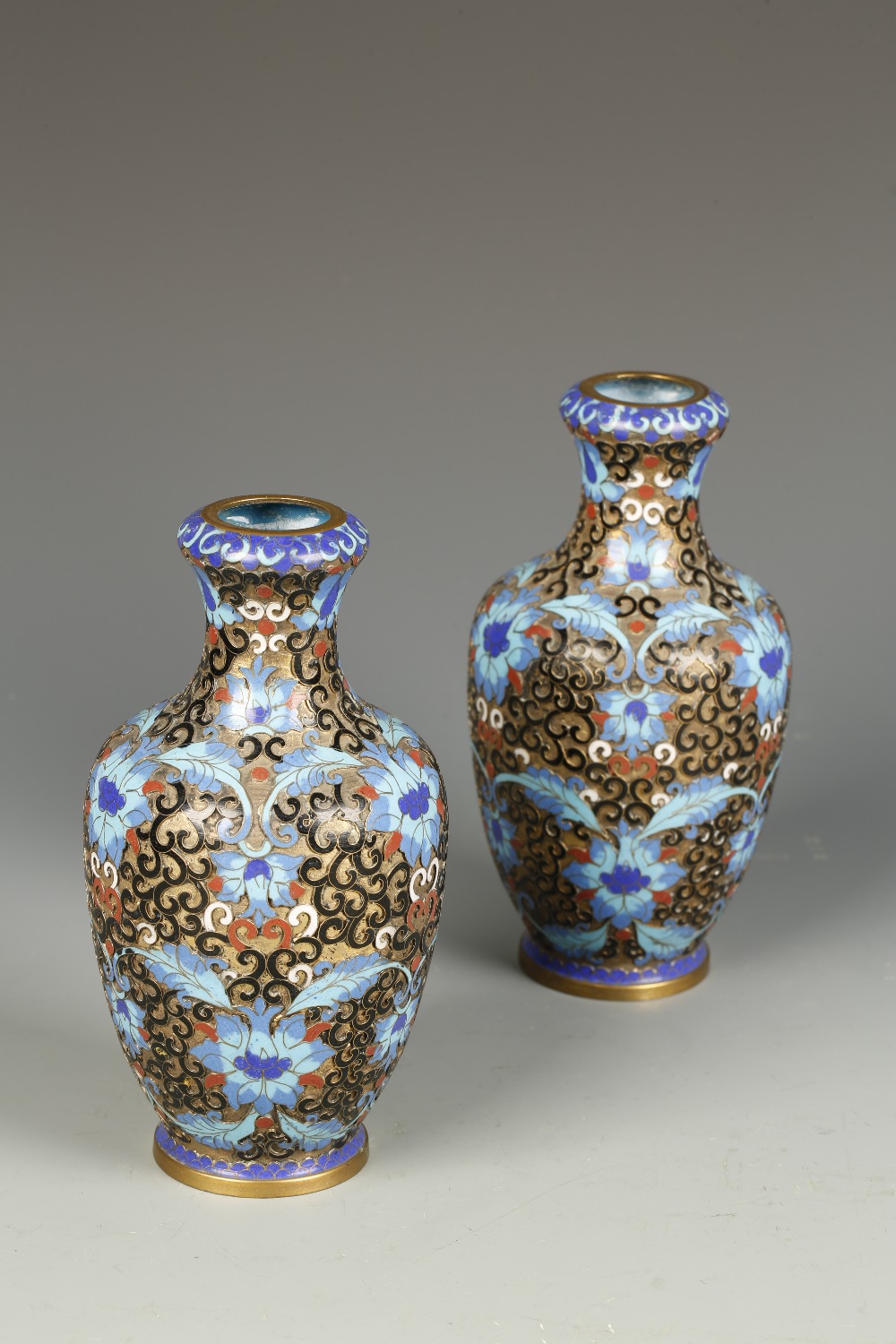 A PAIR OF CHINESE CLOISONNE VASES of baluster form, decorated in shallow relief with flowerheads