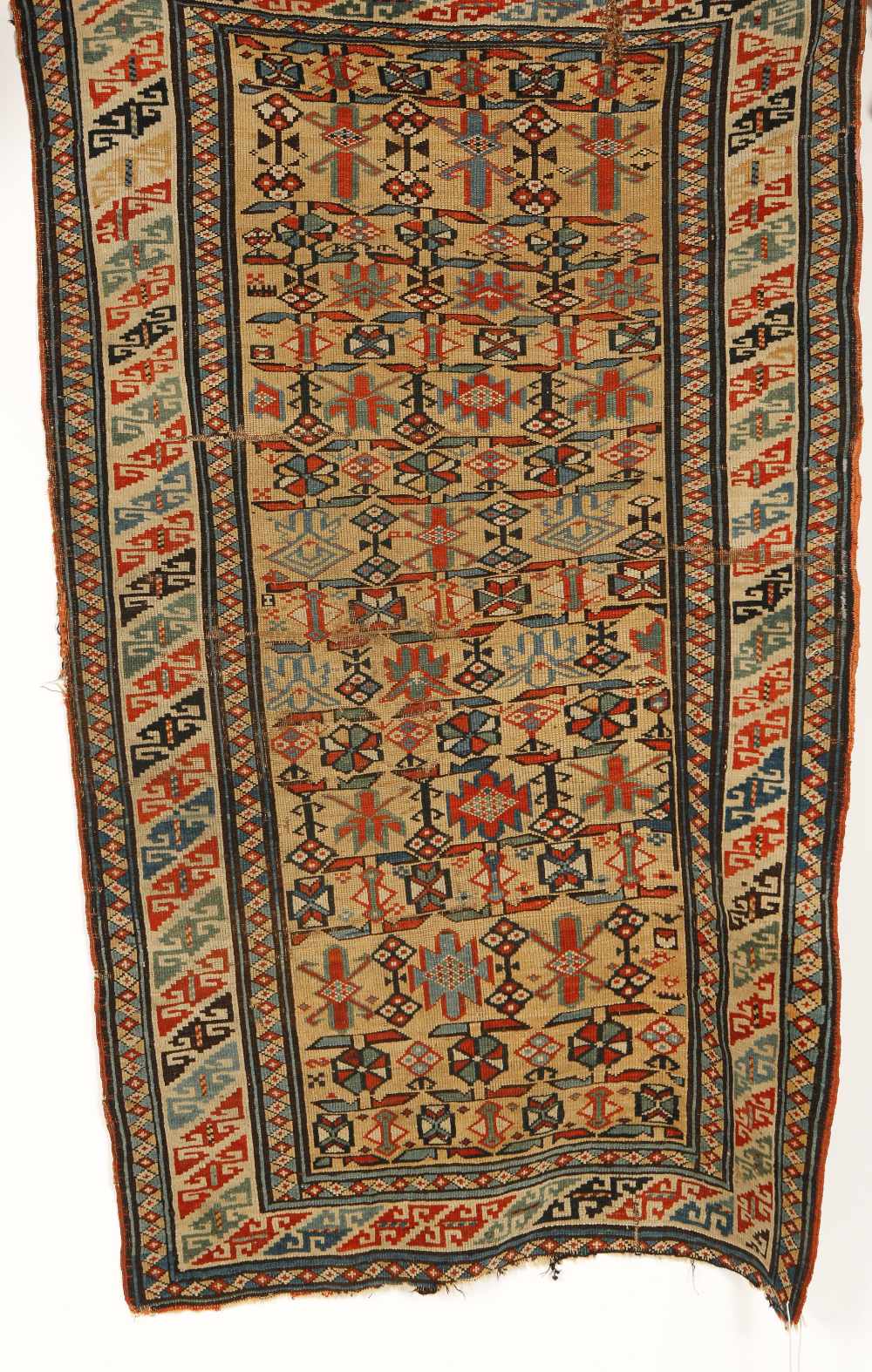 A LATE 19TH CENTURY CAUCASIAN RUG with a central panel and stylised geometric motifs against a