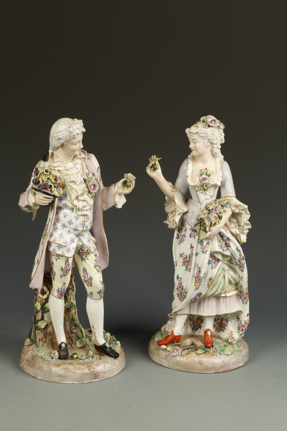 A PAIR OF 19TH CENTURY ""MEISSEN"" FIGURES of a lady and gentleman in floral decorated traditional