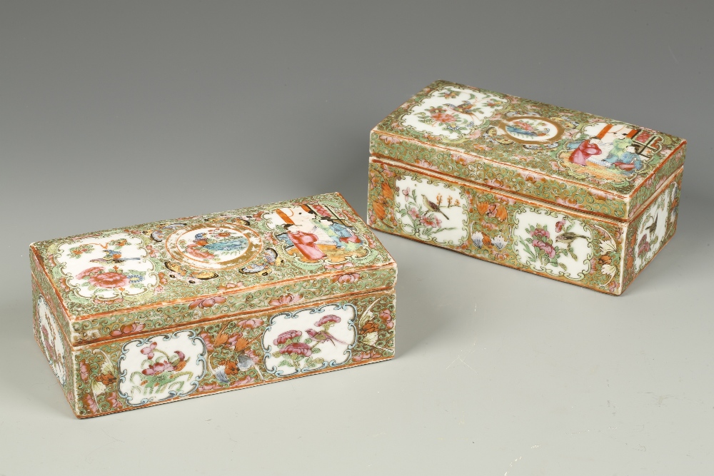 TWO SIMILAR CANTONESE FAMILLE ROSE RECTANGULAR BOXES decorated with panels of figures and birds