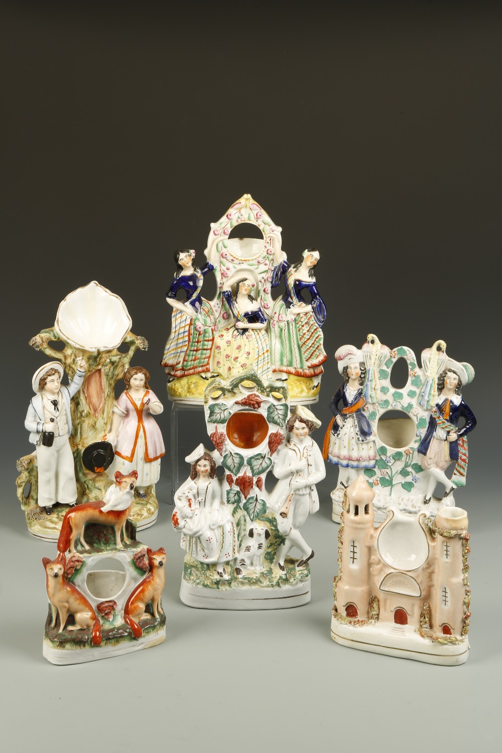 A SELECTION OF STAFFORDSHIRE FLATBACK WATCH HOLDERS including a watch holder flanked by three women