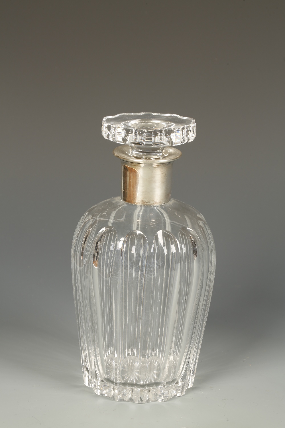 A CUT CLEAR GLASS SPIRIT DECANTER with shouldered fluted body and white metal collar, stamped 835,