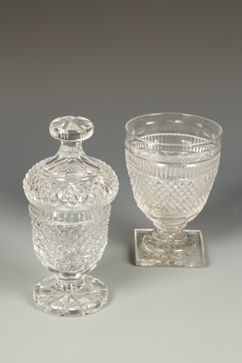 A REGENCY CLEAR AND CUT-GLASS RUMMER with diamond-cut body and pedestal foot, on square base with