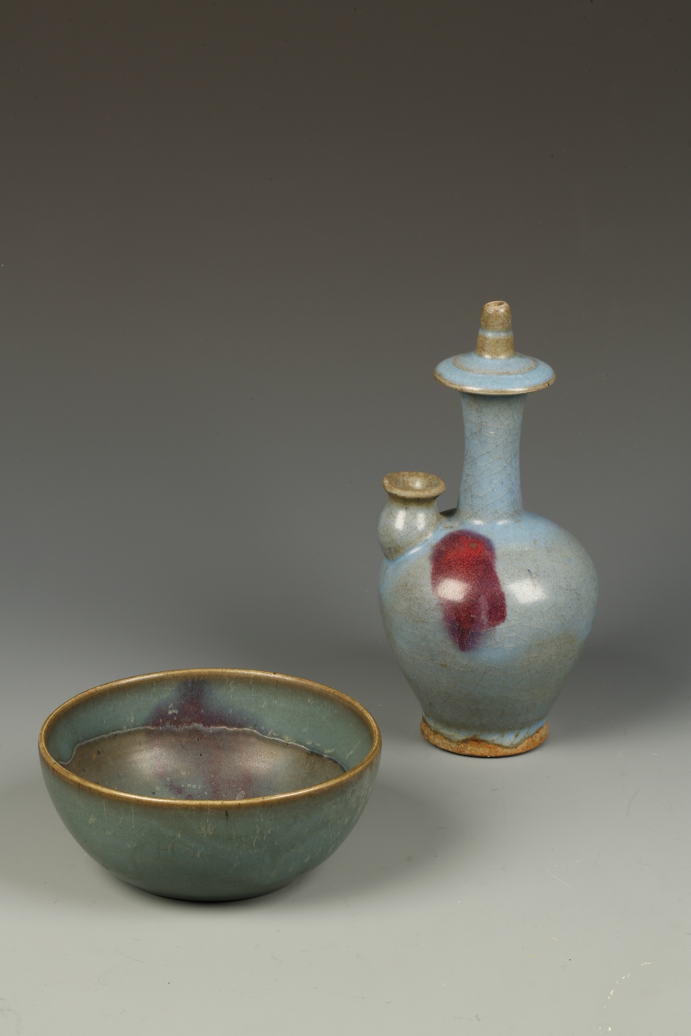 A CHINESE JUN STYLE WATER DROPPER, one side with a purple splash, 9"" high; and a Jun style bowl,