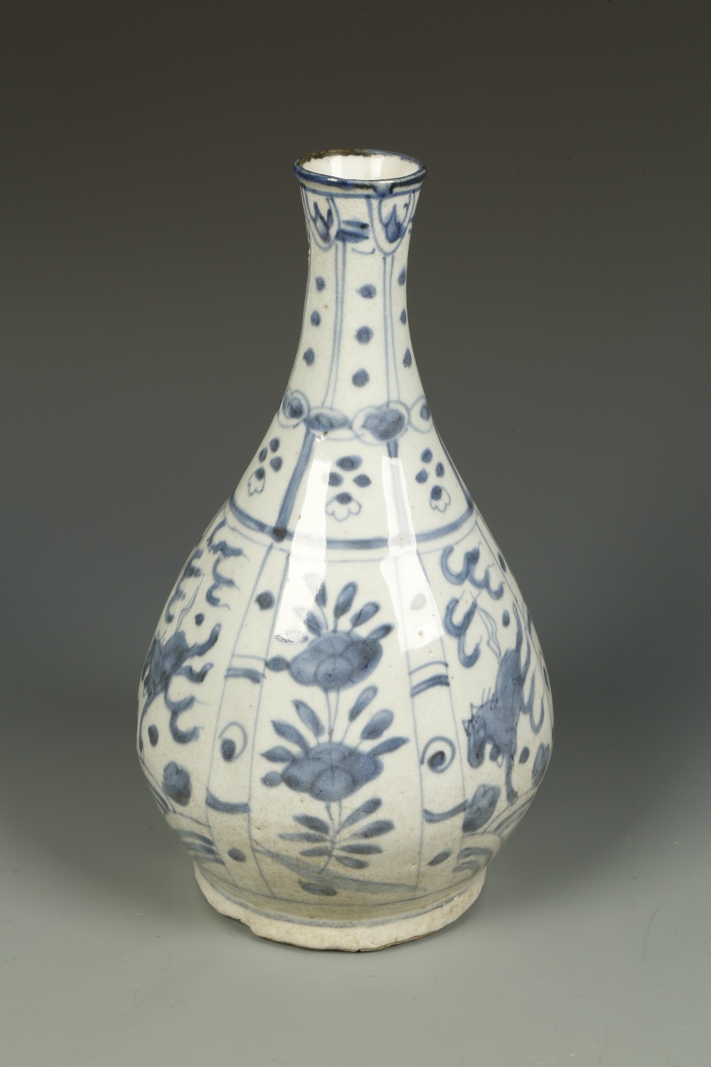 A CHINESE BLUE AND WHITE BOTTLE VASE, the tapering body decorated with alternating panels of horses