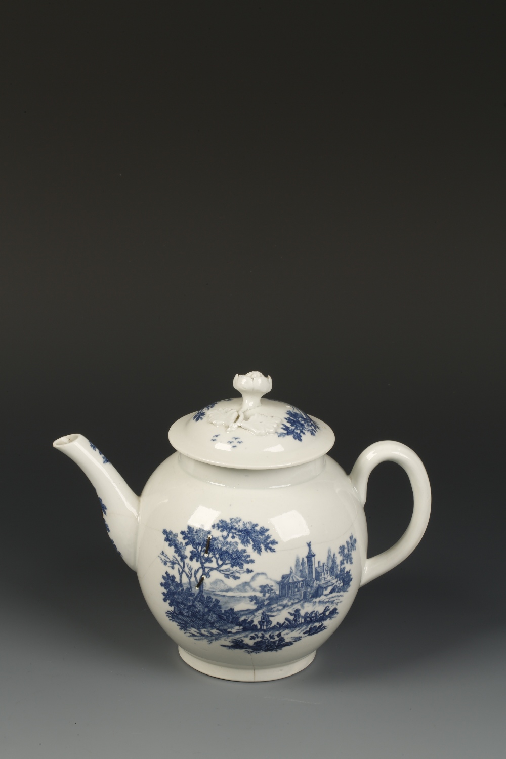 A FIRST PERIOD WORCESTER PORCELAIN TEAPOT AND COVER transfer decorated in blue with a mill scene