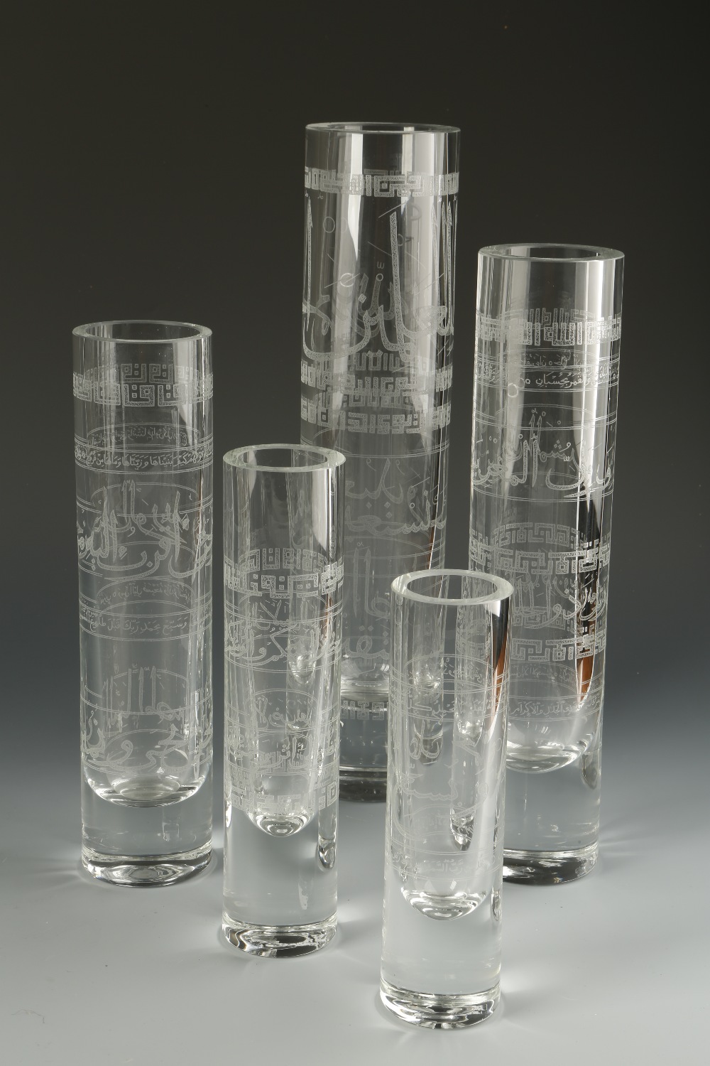 A SET OF FIVE GRADUATED CYLINDER VASES retailed by Thomas Goode, made for the Islamic market, each