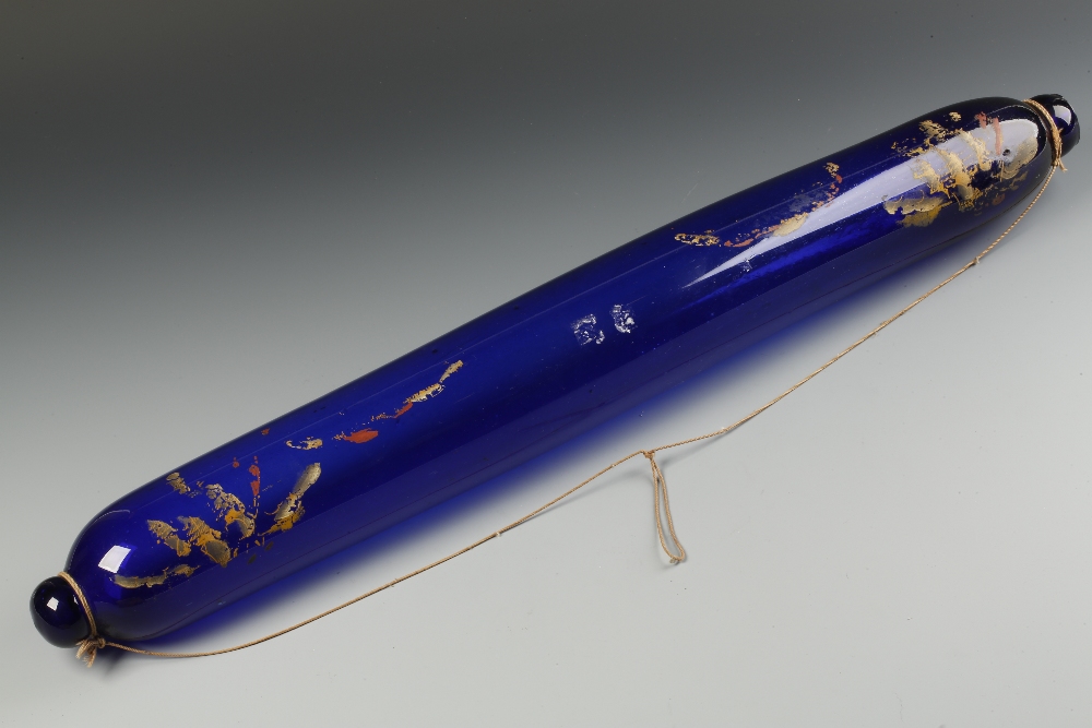 A LARGE NOVELTY "BRISTOL" BLUE GLASS ROLLING PIN with gilt and coloured painted decoration, 29"