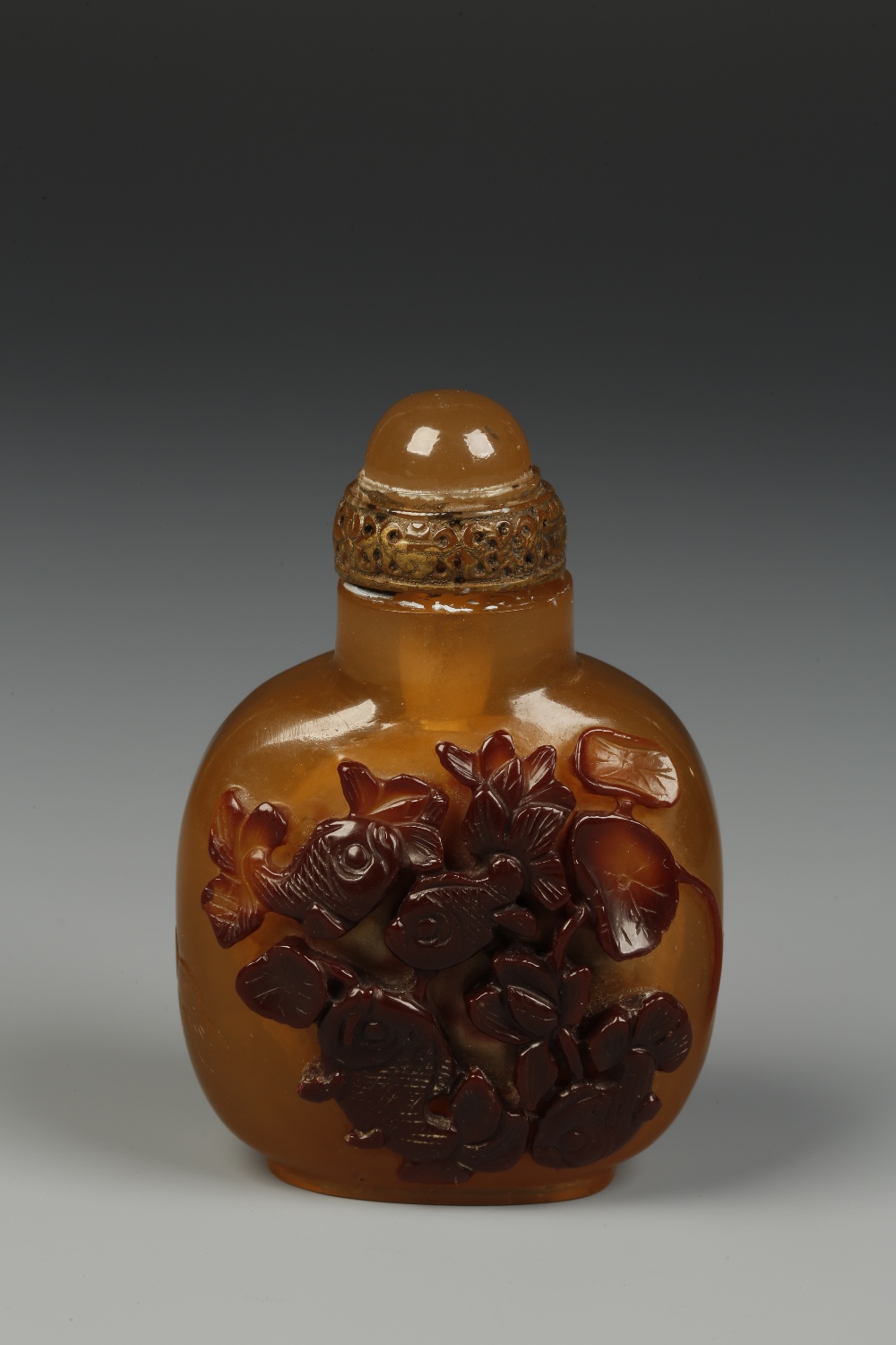 A CHINESE SNUFF BOTTLE IMITATING CHALCEDONY, decorated with fish and incised calligraphy, 2.25"