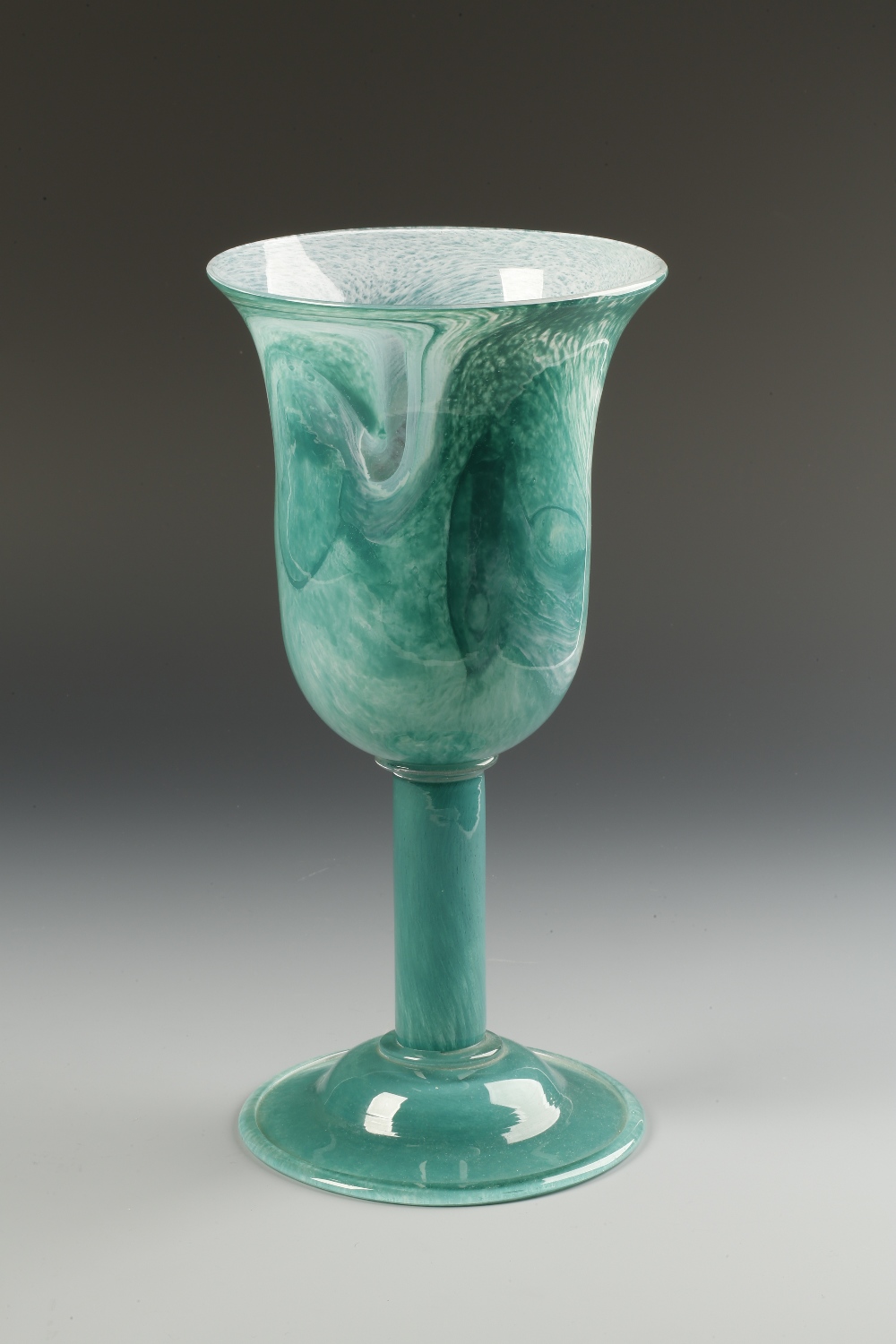 GRAY-STAN: A MOTTLED GREEN GOBLET-SHAPED VASE with a tall flared body on a straight stem with