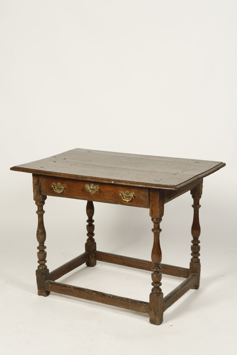 AN EARLY 18TH CENTURY OAK SIDE TABLE, the rectangular top with a moulded border above a single