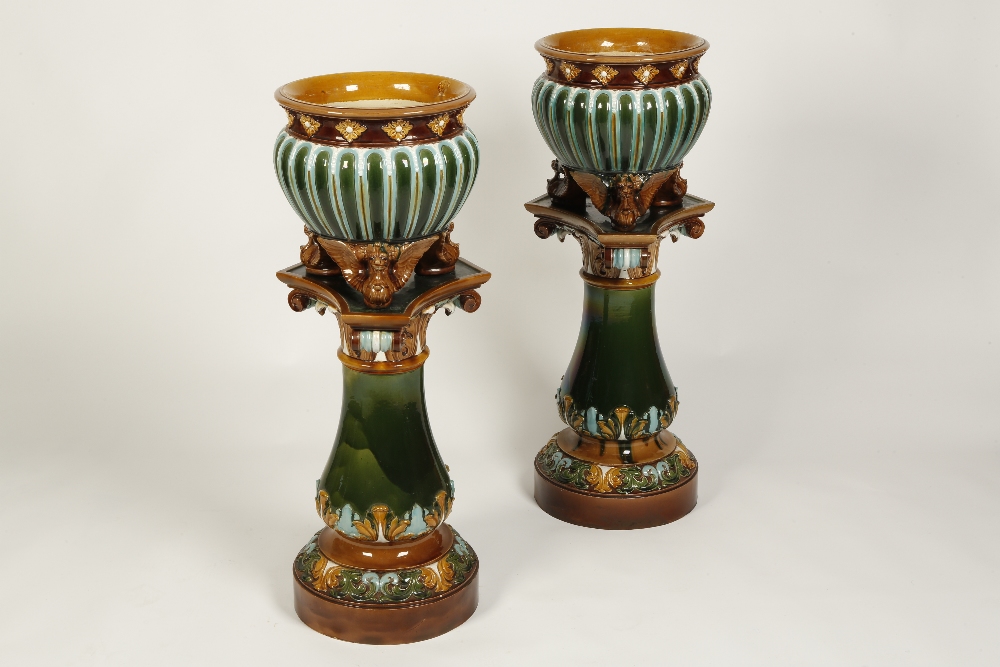 A PAIR OF DOULTON LAMBETH JARDINIERES AND STANDS with turquoise and green stop fluted bodies, with