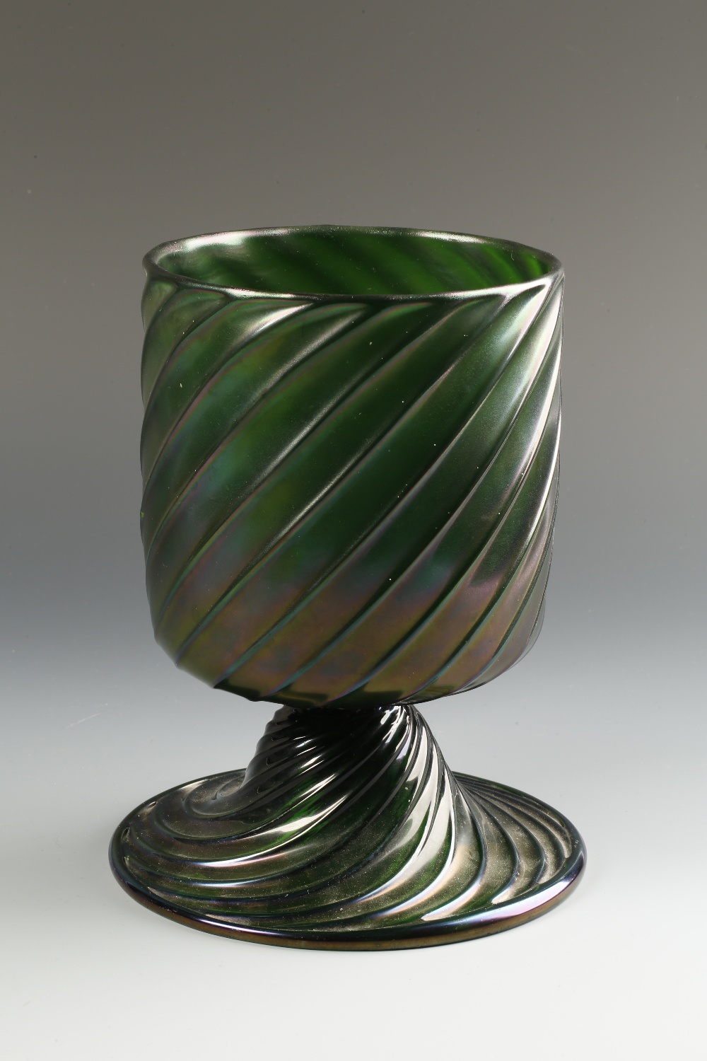 A LOETZ STYLE WRYTHEN IRIDESCENT GREEN GLASS VASE with a straight-sided bowl on a broad spreading