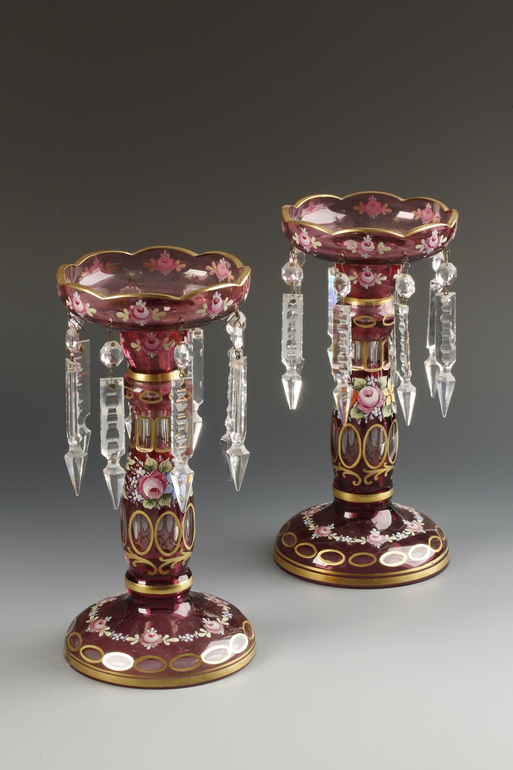 A PAIR OF BOHEMIAN STYLE TABLE LUSTRES with amethyst bodies all over decorated with gilt and