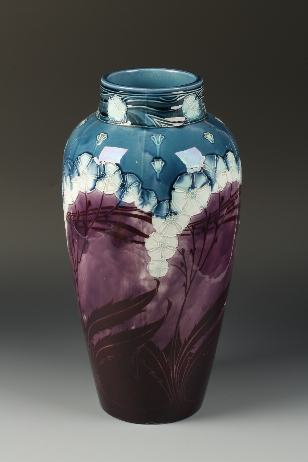 AN ART NOUVEAU VASE of ovoid form with slip decorated flowers and fan motifs, in the manner of