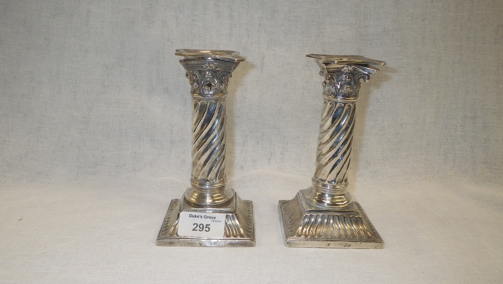 A pair of silver dwarf column form table candlesticks