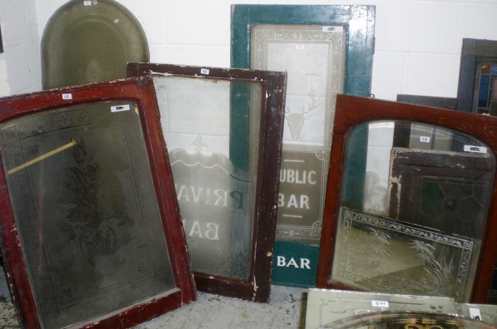 A collection of four windows, all with etched panels, one `Public Bar`