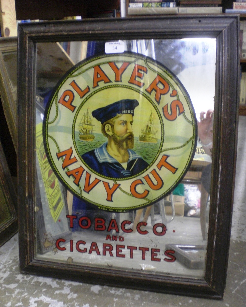 A Player`s advertising mirror with a central roundel above `Tobacco and Cigarettes`