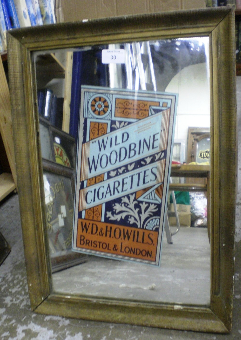 A cigarette advertising mirror `Wild Woodbine Cigarettes`