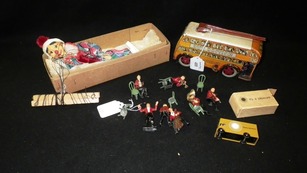 A clockwork tin-plate transport bus, a puppet and other toys