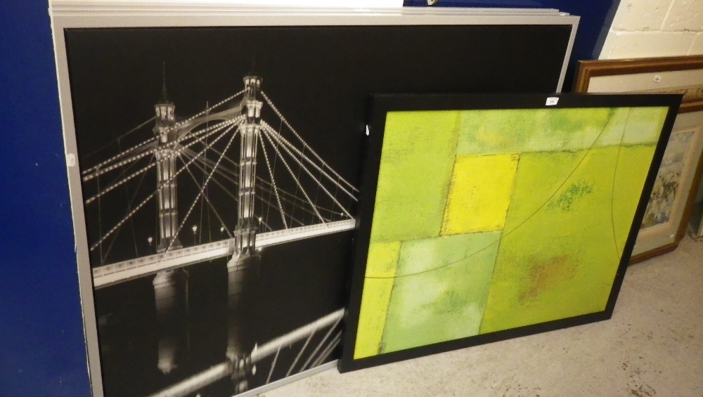 Three framed photographs of cityscapes and a modern abstract painting