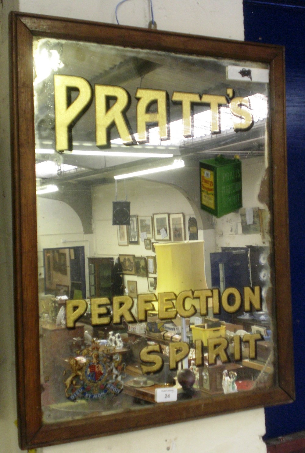 An advertising mirror `Pratt`s Perfection Spirit` with a Royal Coat-of-Arms and oil can