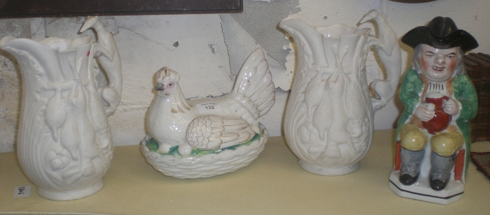 A pair of Victorian relief moulded jugs, a Toby jug and an egg container