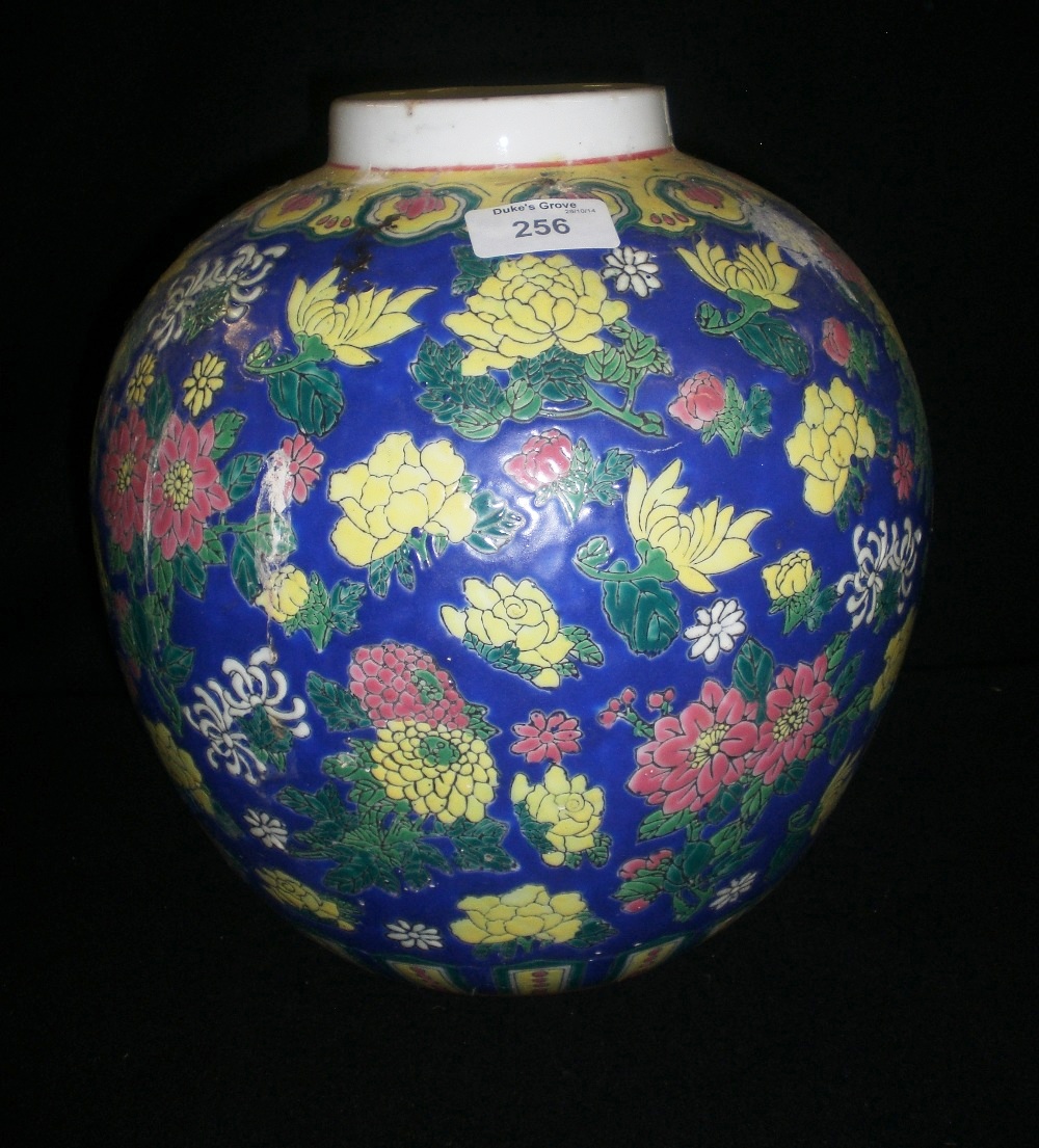 A large Chinese Export vase, decorated with flowers against a blue ground