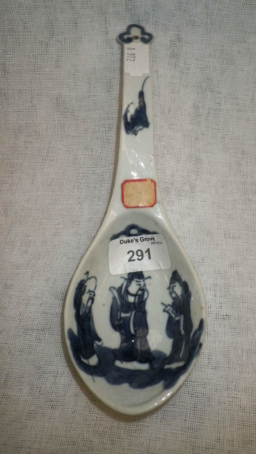 A Chinese serving spoon decorated with three characters and a bat