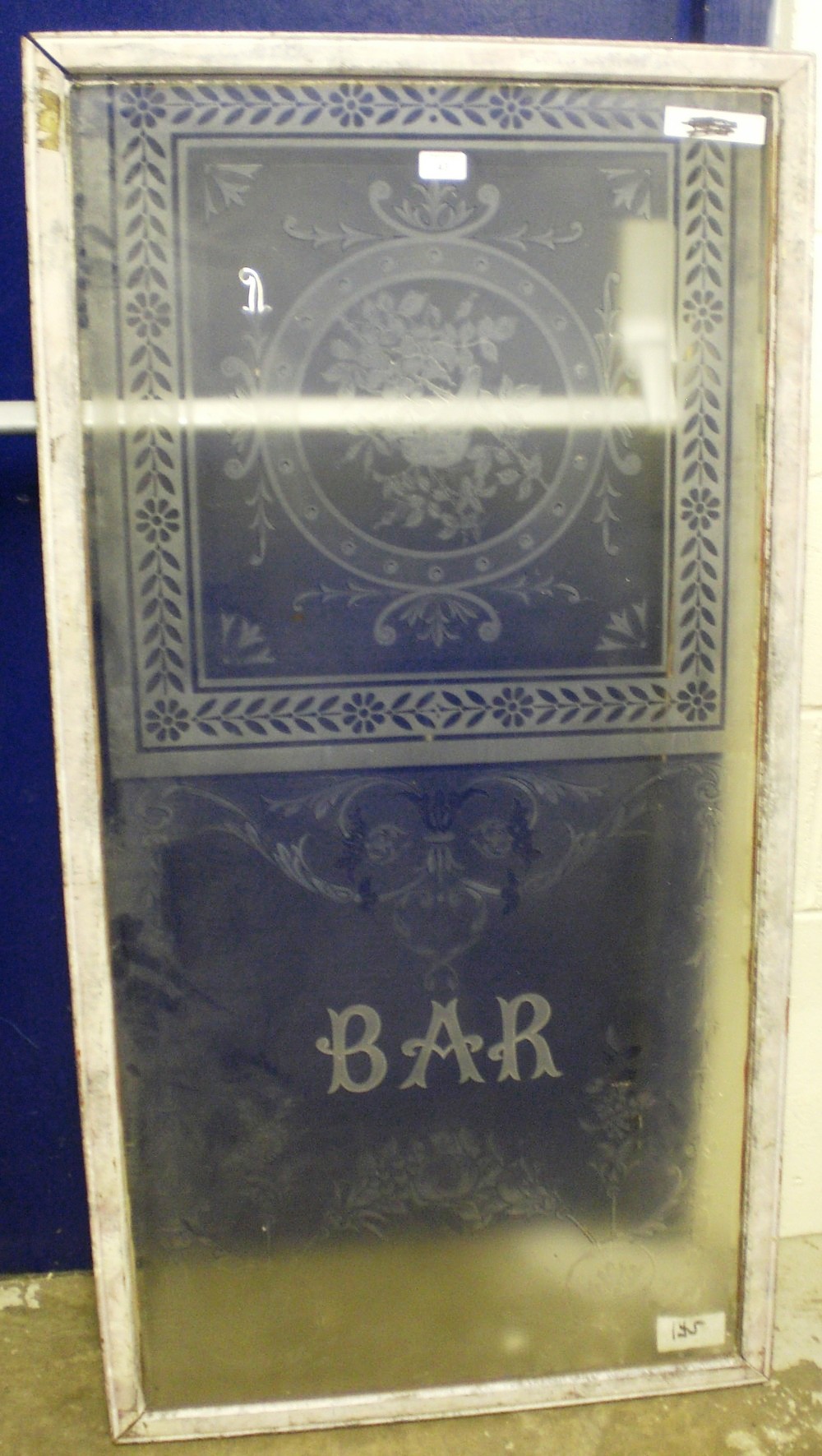 A large etched pub window inscribed `Bar`