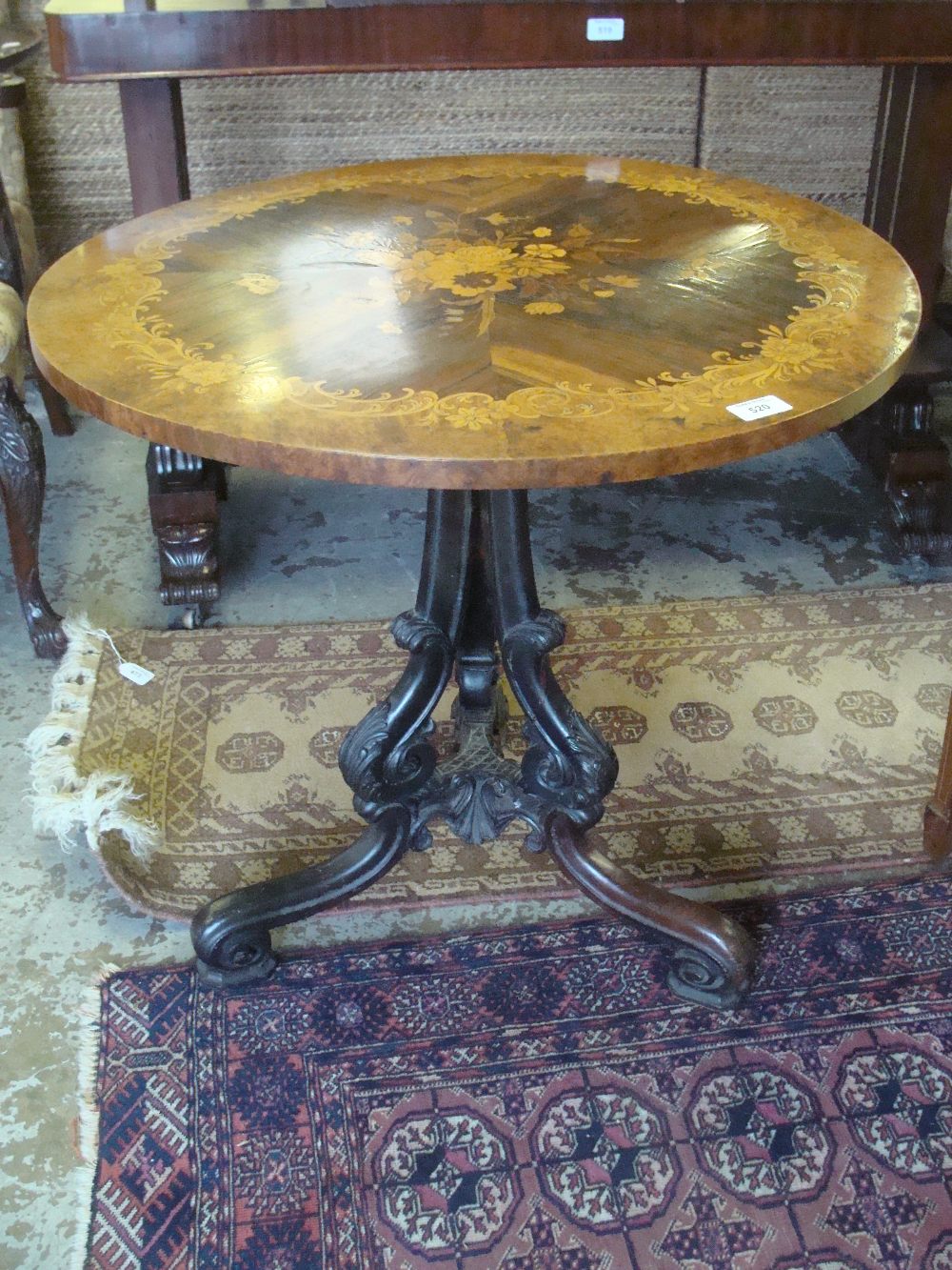 A Victorian tip-top table on tripod support with rosewood figured walnut and marquetry decorated