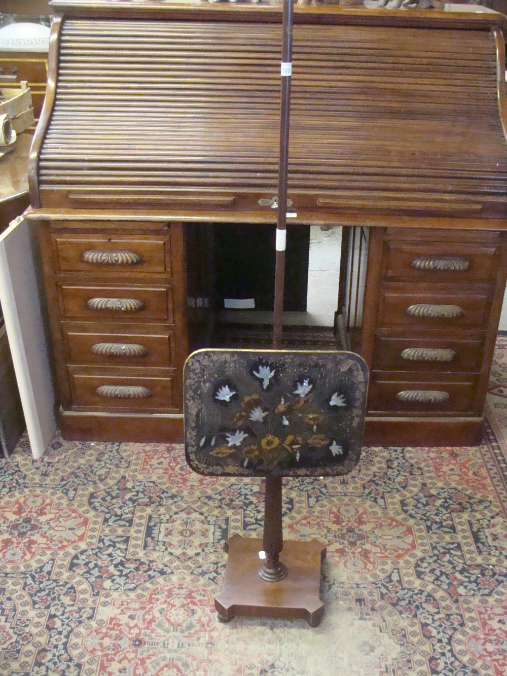 A 19th century mahogany pole screen with papier mache panel and mother-of-pearl inlay