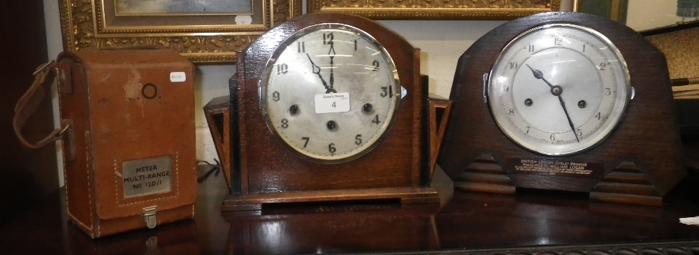 An Art Deco oak-cased mantel clock, another similar and a vintage Post Office volt meter in leather