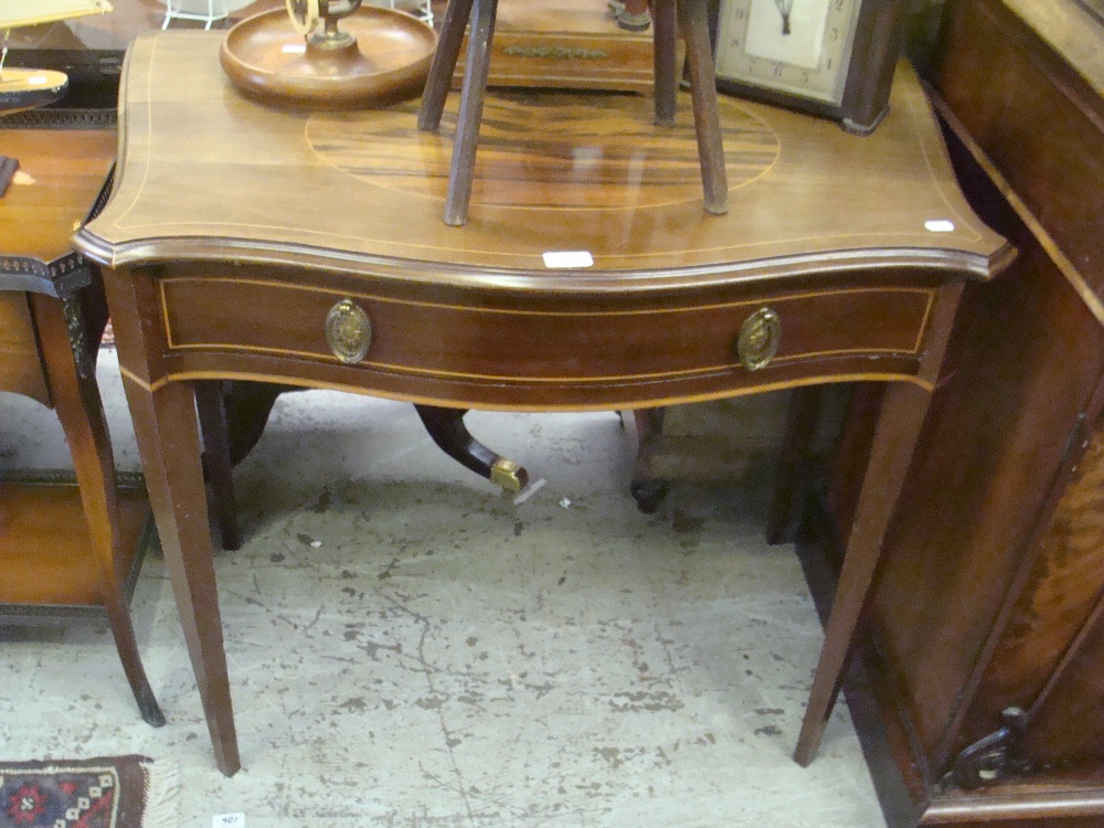 An Edwardian mahogany serpentine fronted hall table, fitted a single drawer