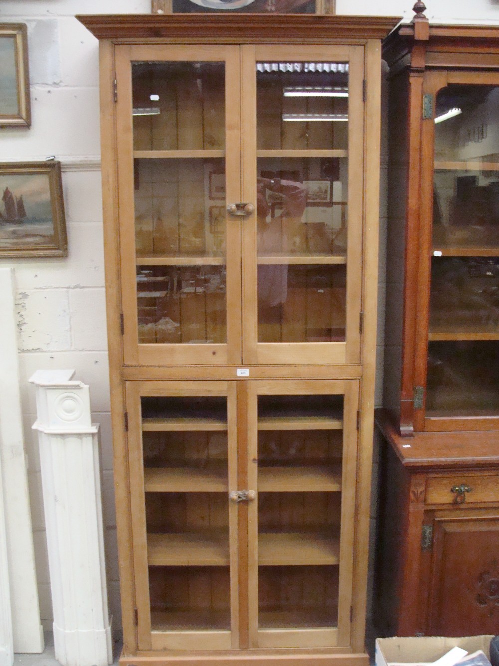 A stripped pine glazed bookcase of tall proportions