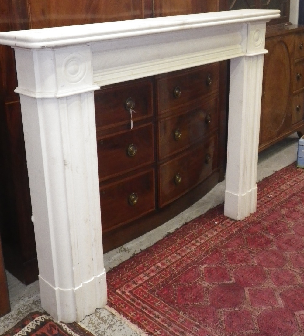 A Regency design white limestone fireplace surround