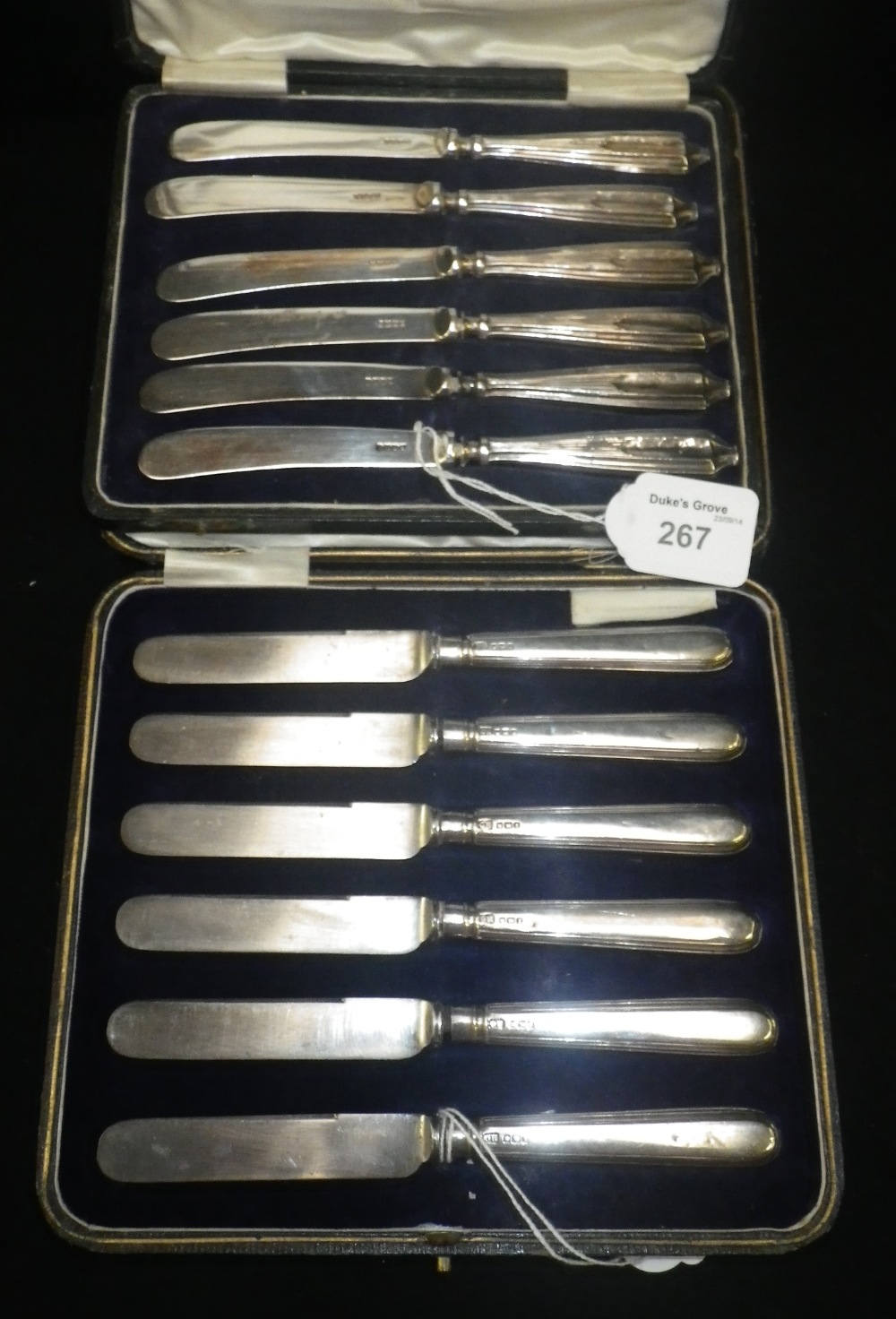 A cased set of six silver handled tea knives and another similar set